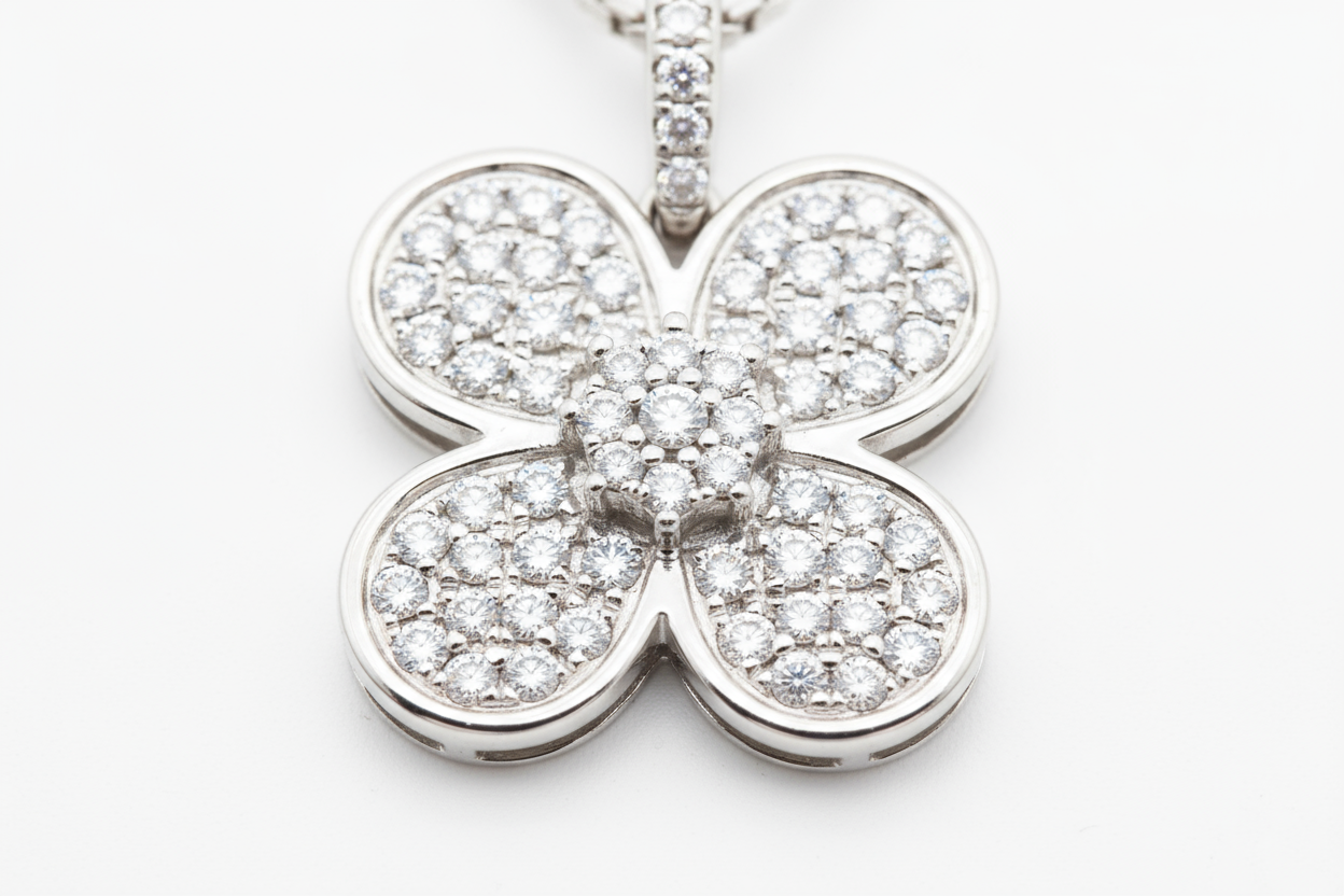 zoomed in picture of a diamond plated 4-clove pendant on a white background